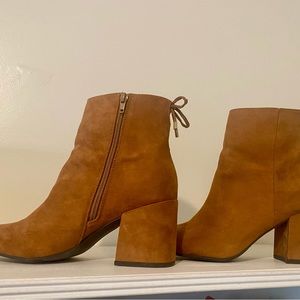 Size 9.5 tan suede booties with tassel tie design and side zipper entry.